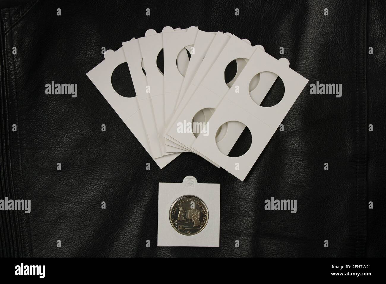 Coin holders for coin collectors isolated on the black background. Financial investment concept