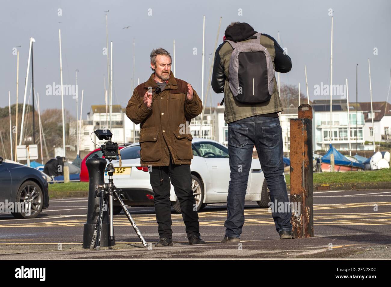 Professional Photographer Mike Browne Making An Educational Photography Tutorial Whilst Being Filmed, Mudeford Quay UK Stock Photo