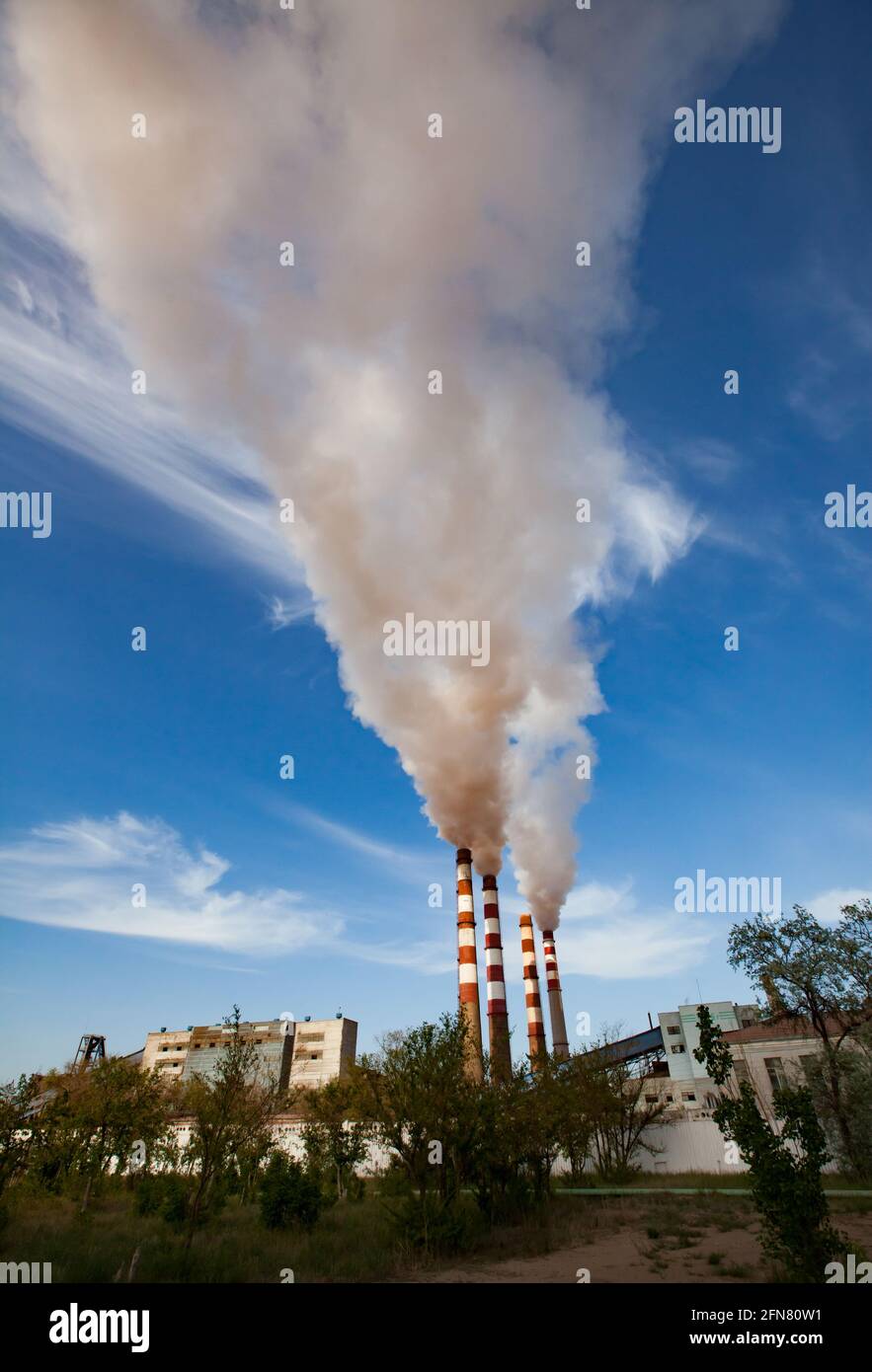 Pavlodar thermal electric station. Smoke stacks with white smoke. Stock Photo