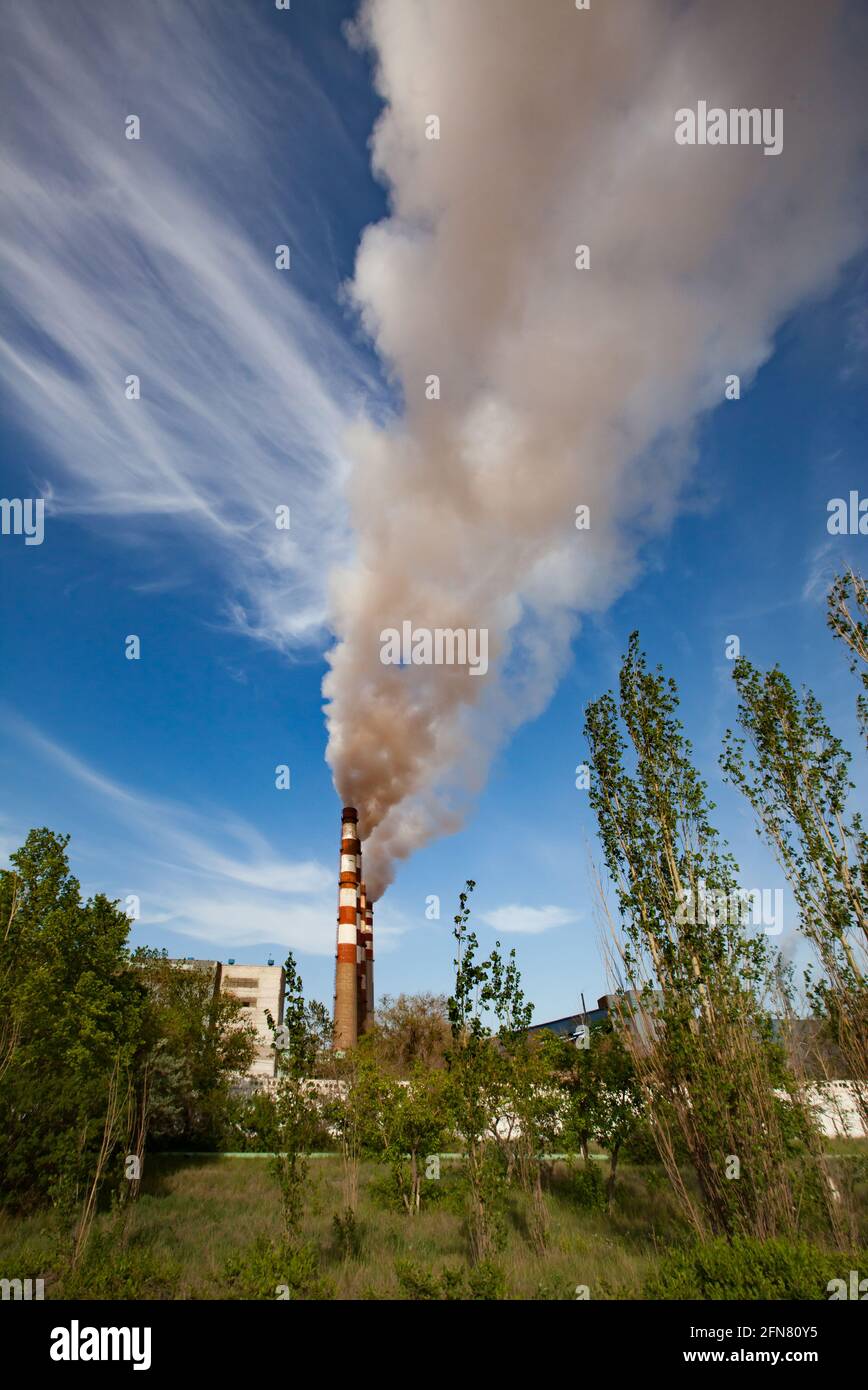 Pavlodar thermal electric station. Smoke stacks with white smoke. Stock Photo