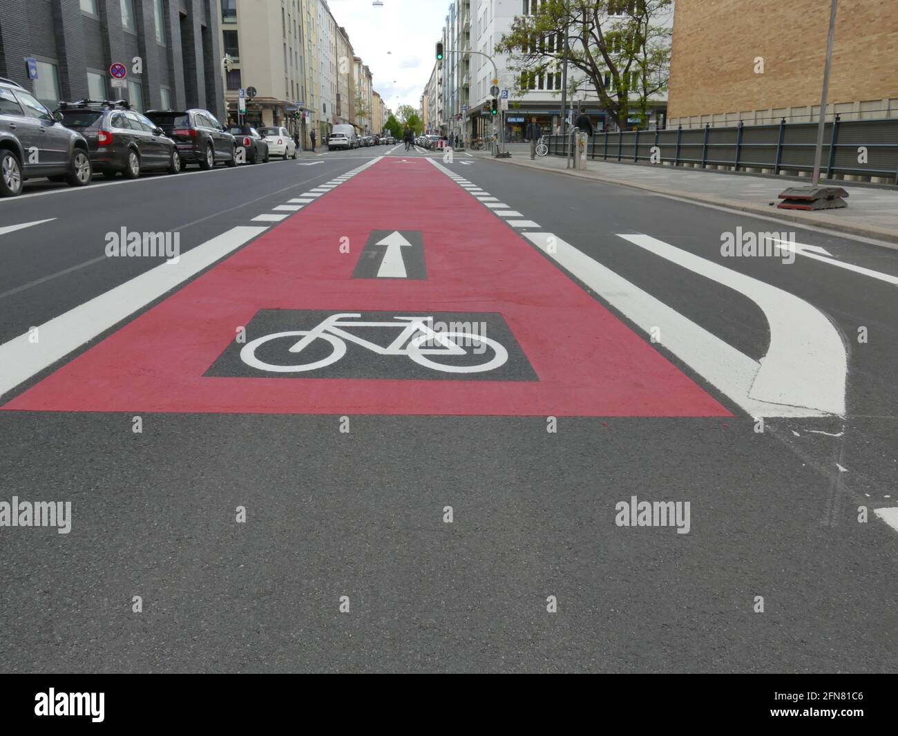 Bikeway, bicykle lane, red colored, germany, bike symbol, oneway symbol, Munich. Stock Photo