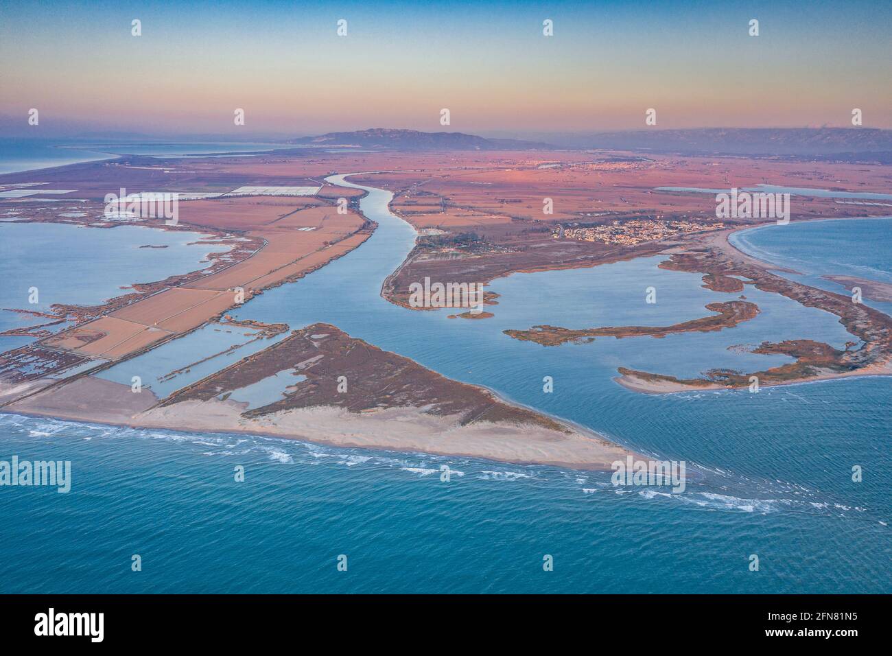 Aerial view of the river mouth in the Ebro Delta at sunrise (Tarragona, Catalonia, Spain) ESP: Vista aérea de la desembocadura del Delta del Ebro Stock Photo