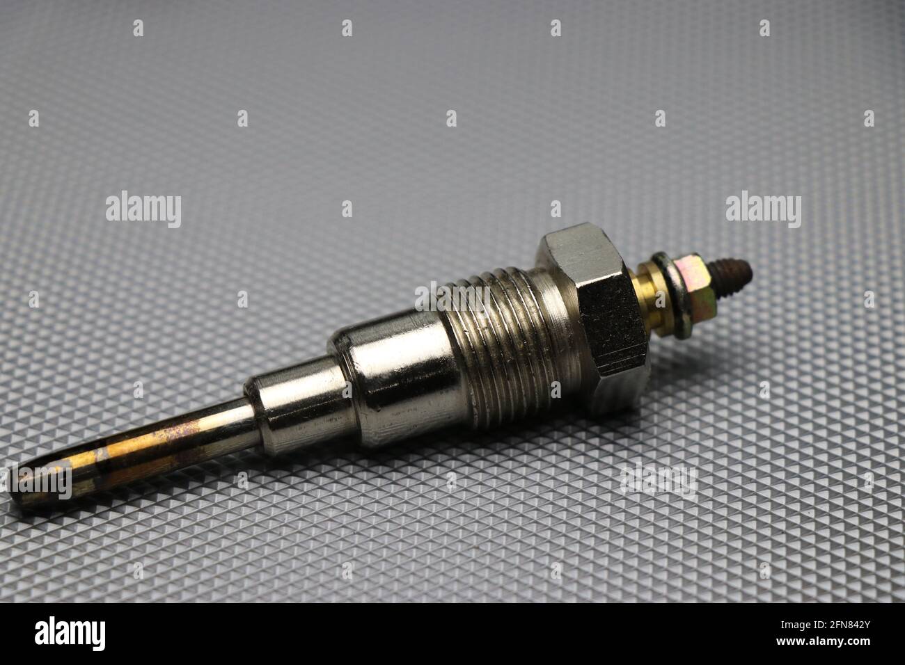 Glow plug which is used in diesel engines cylinder for initiating combustion of fuel. Diesel engine glow plug Stock Photo