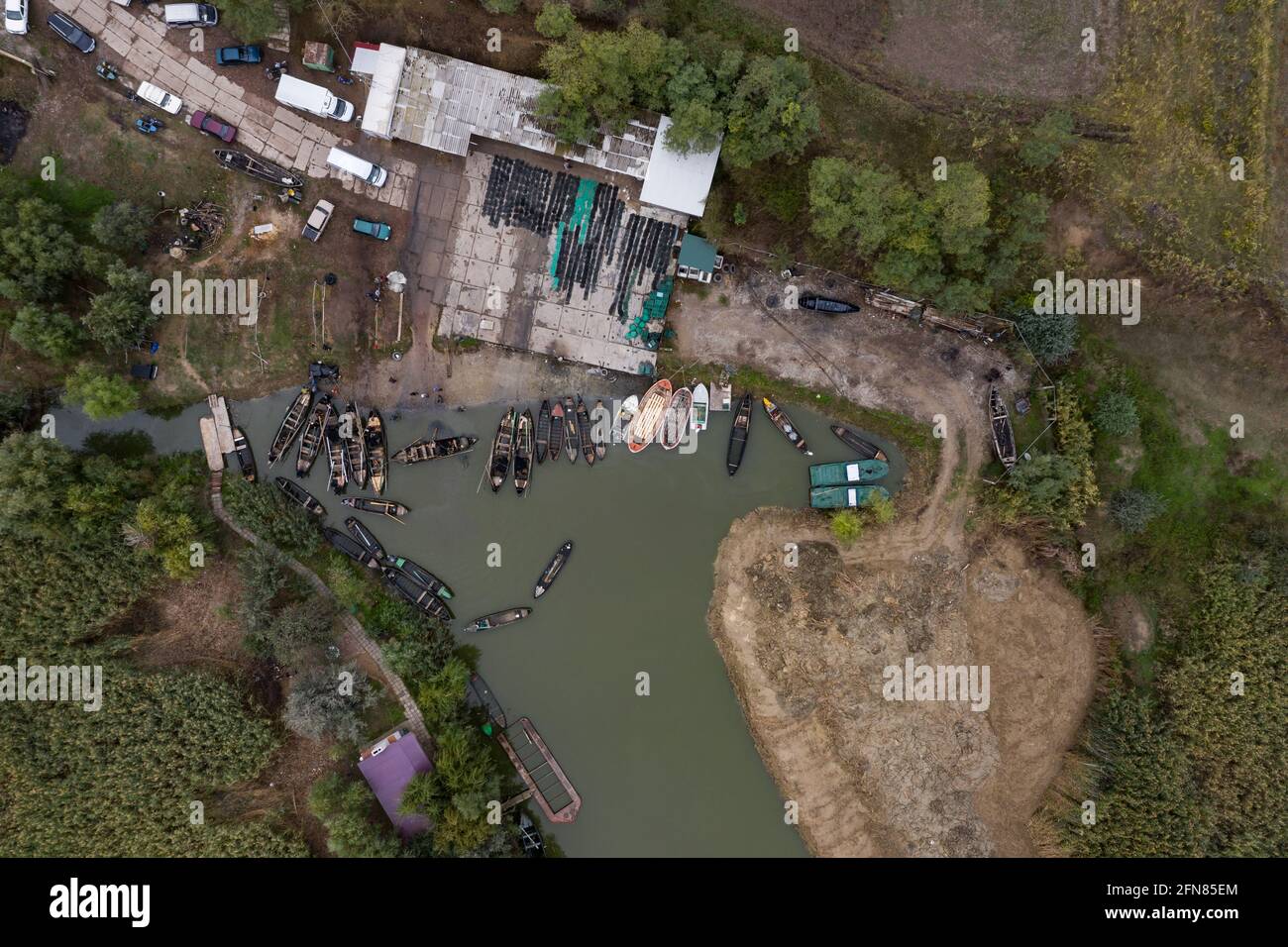 Aerial view of fishermen pier dock with many fishing boats parked in a ...