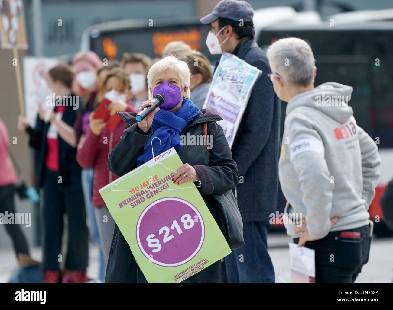 Hamburg, Germany. 15th May, 2021. A woman with a poster reading '150 years of criminalisation are enough! §218' speaks at the day of action for the abolition of § 218 StGB and legalization of abortion on the Jungfernstieg. The demands to politics were emphasized by a human chain. Credit: Axel Heimken/dpa/Alamy Live News Stock Photo