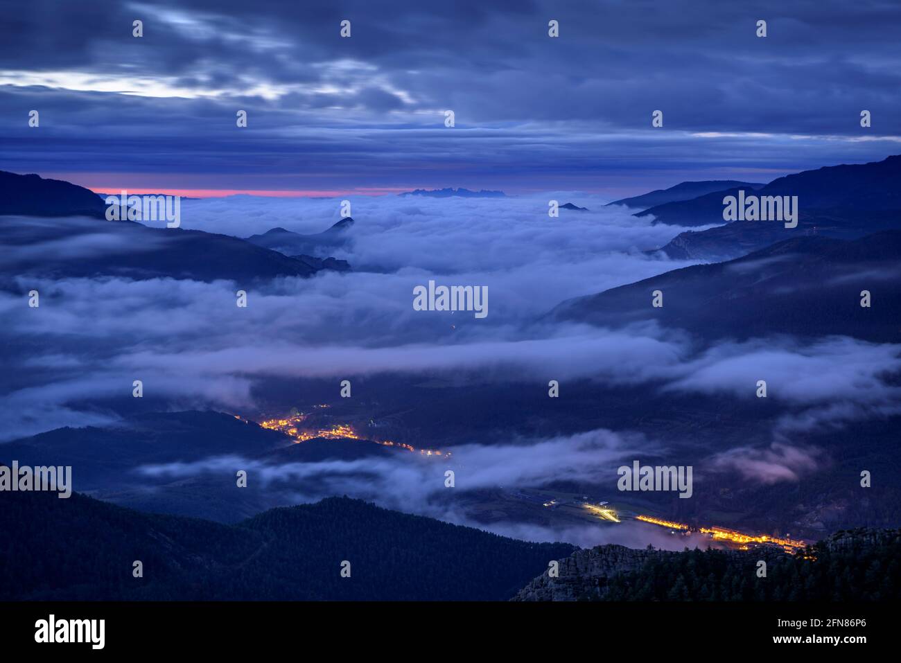 Sunrise with fog and clouds, seen from the Devesa viewpoint in Coll de Pal (Barcelona province, Catalonia, Spain, Pyrenees) Stock Photo