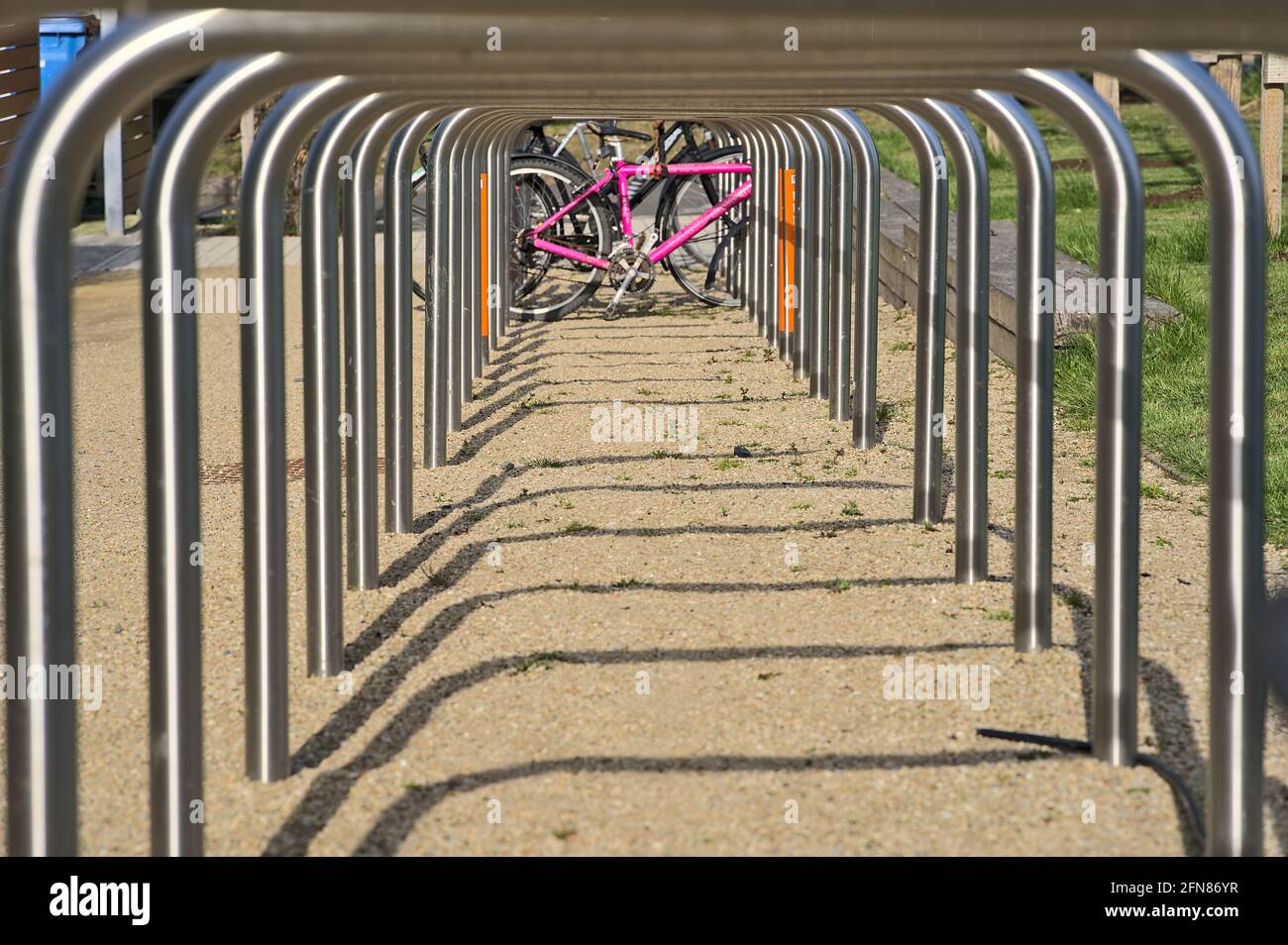 Beautiful closeup low ground view of bike parking rack tubes aligned in
