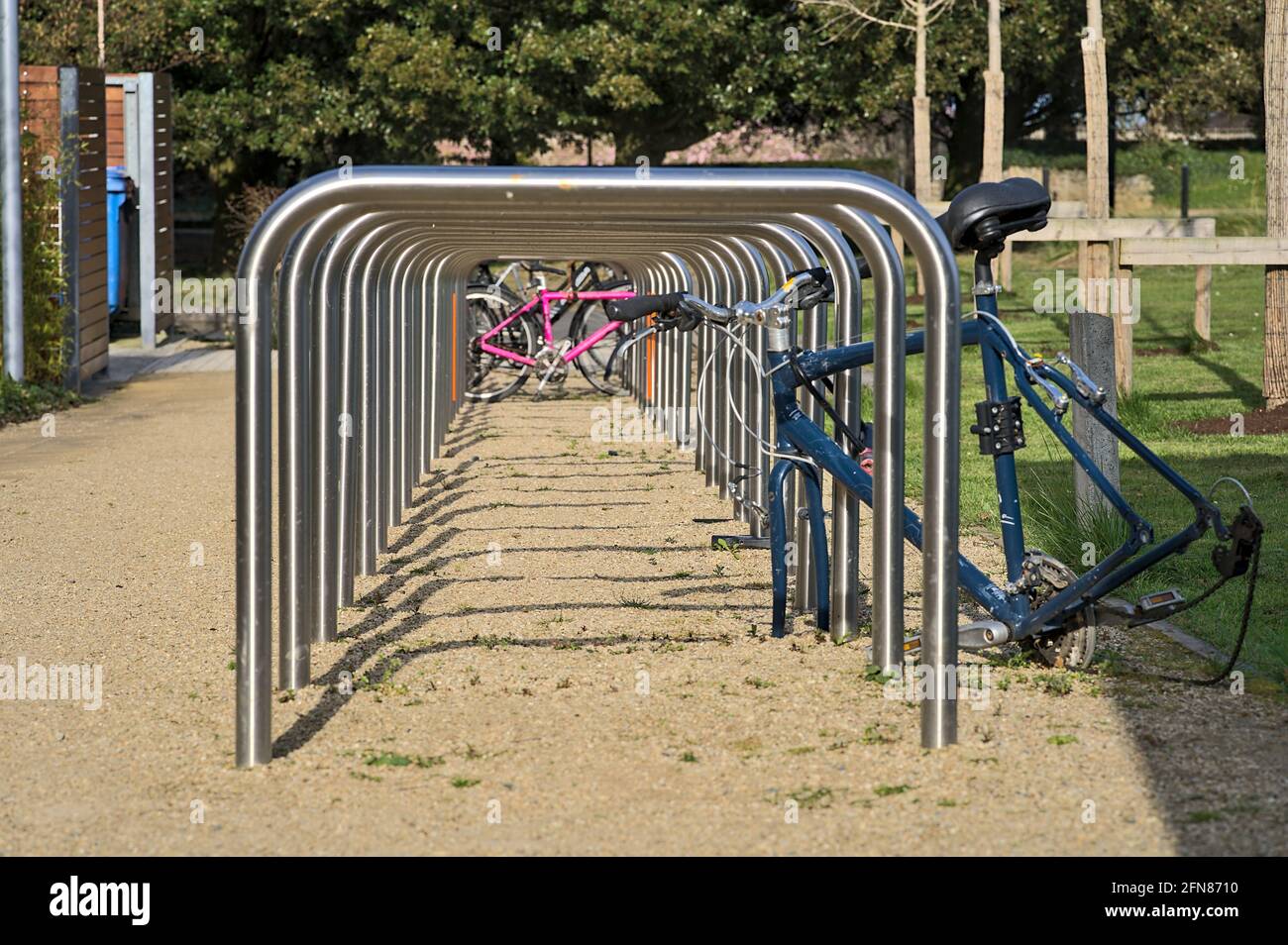 Beautiful closeup low ground view of bike parking rack tubes aligned in
