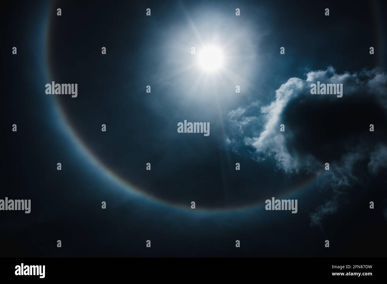 Moon halo phenomenon. Beautiful night landscape of dark blue sky and bright ring around the moon effect. Serenity nature background. The moon taken wi Stock Photo