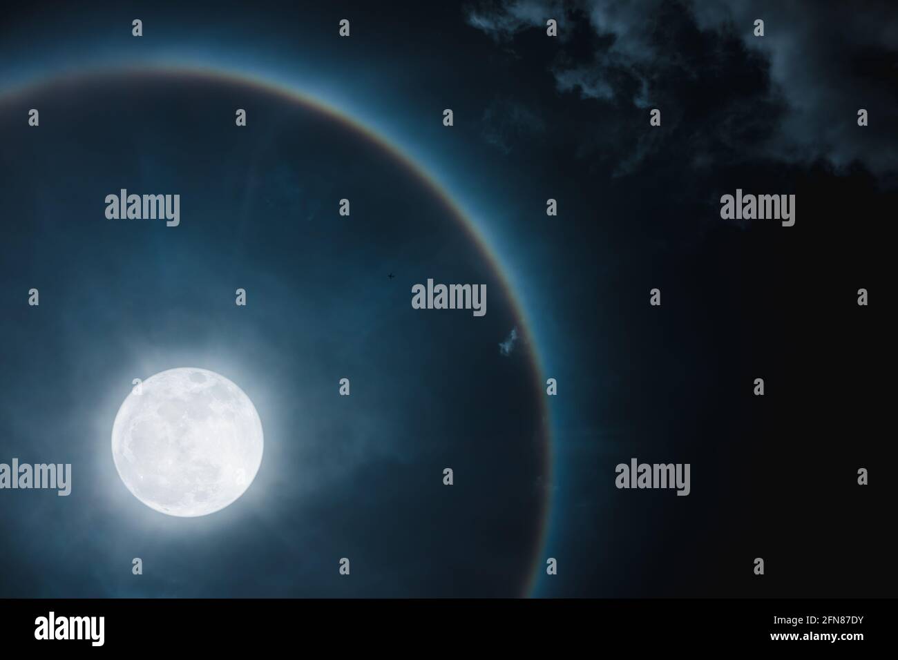 Moon halo phenomenon. Beautiful night landscape of dark sky and bright ring around the moon effect. Serenity nature background. The moon taken with my Stock Photo