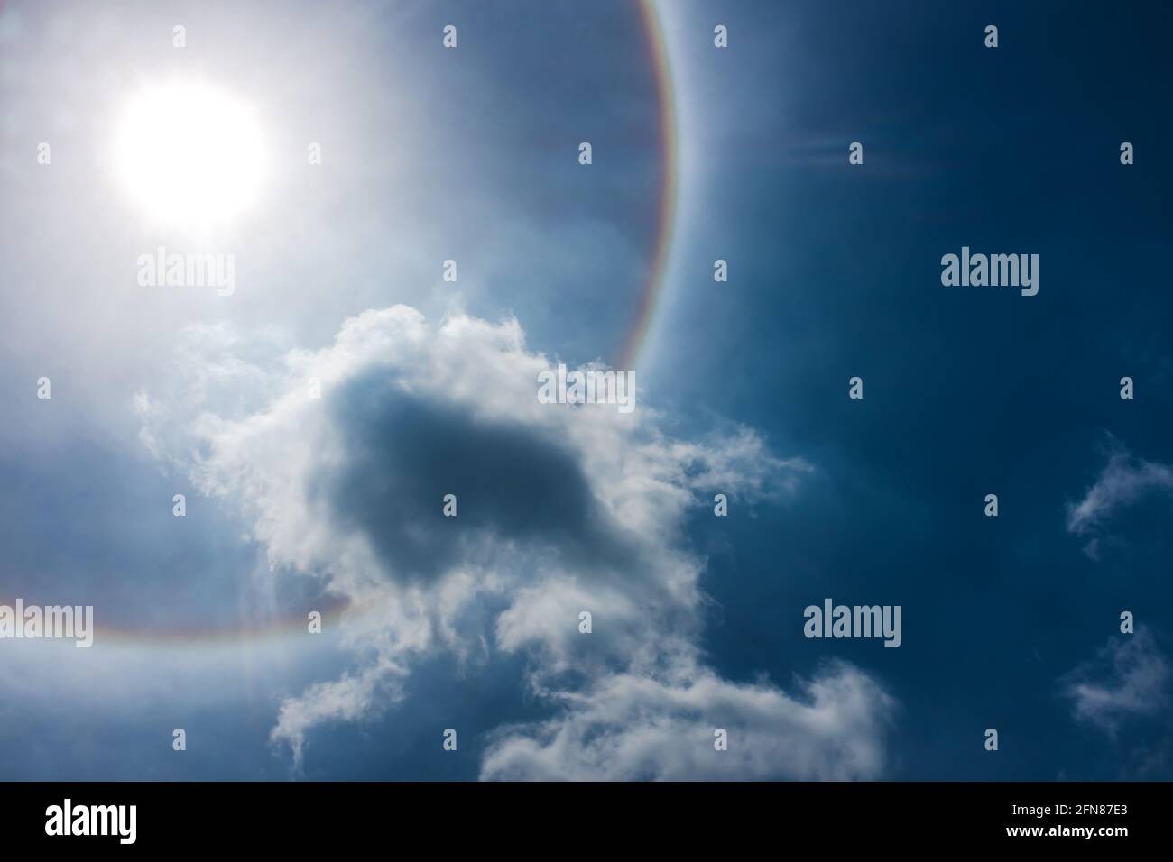 Fantastic beautiful sun halo phenomenon. Landscape of sky and circular rainbow around the sun. Serenity nature background. Outdoor with bright sunligh Stock Photo