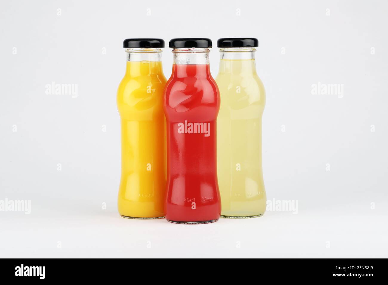 Glass fruit juice bottle isolated on white background. Stock Photo