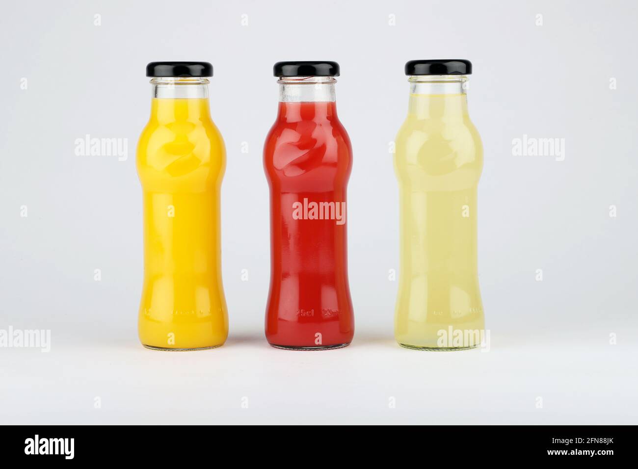 Glass fruit juice bottle isolated on white background. Stock Photo