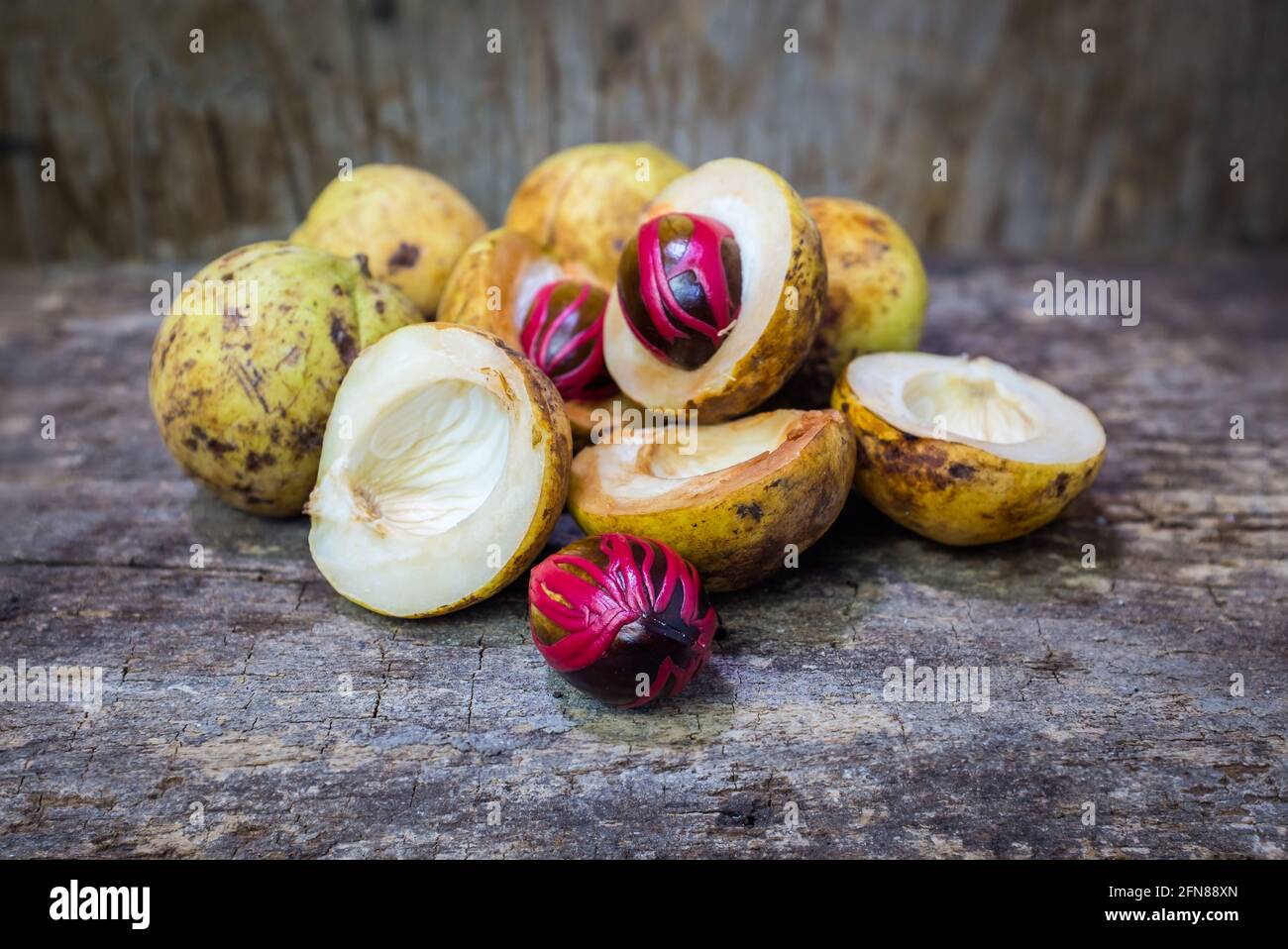 Pile of fresh nutmeg fruit with red placentalike cover of seed of