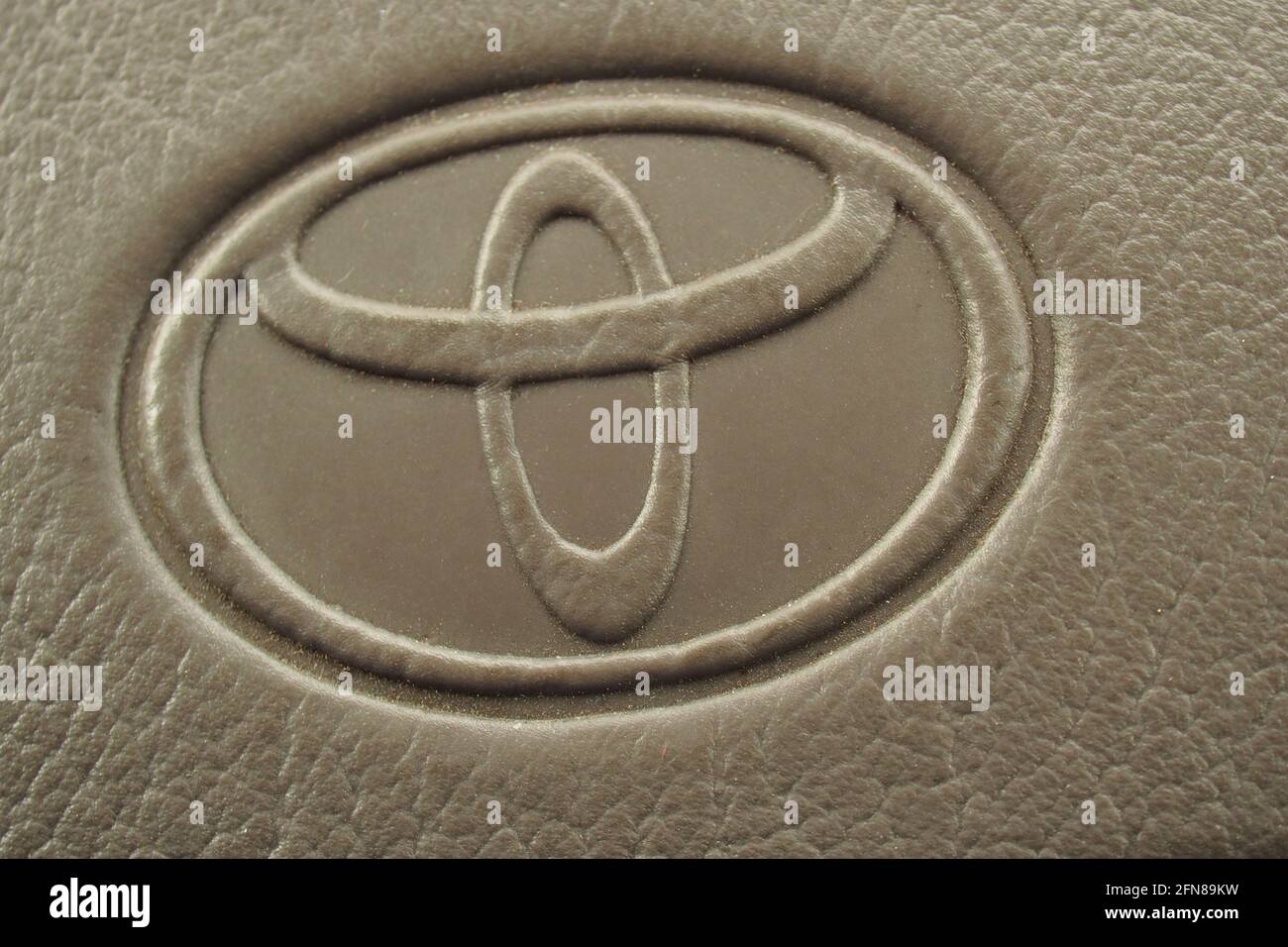 The Toyota logo embossed on the inside fabric of a car in grey Stock Photo