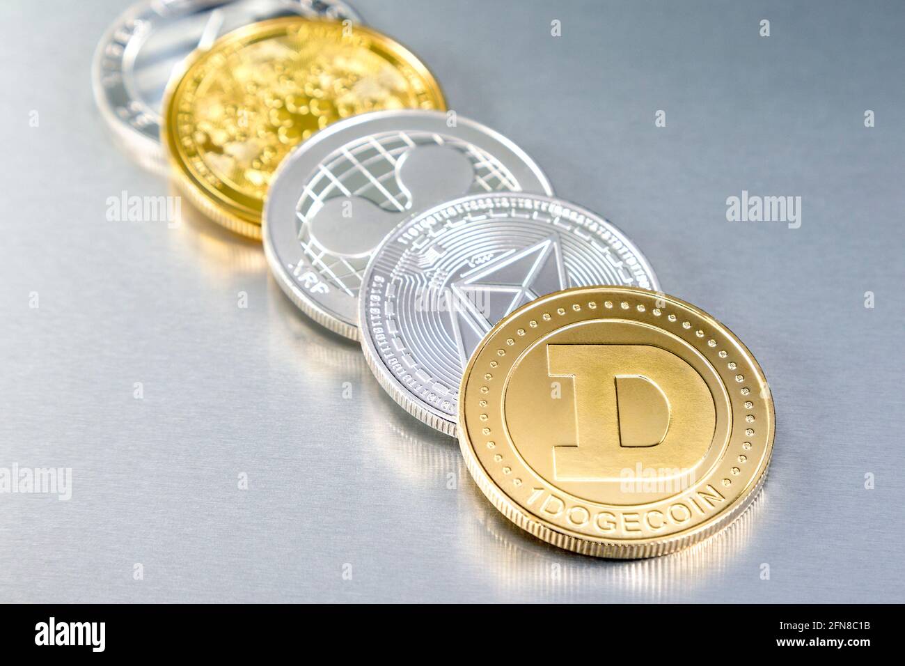 Selection of cryptocurrency token alt coins including ethereum classic, dogecoin, ripple, cardano and litecoin Stock Photo