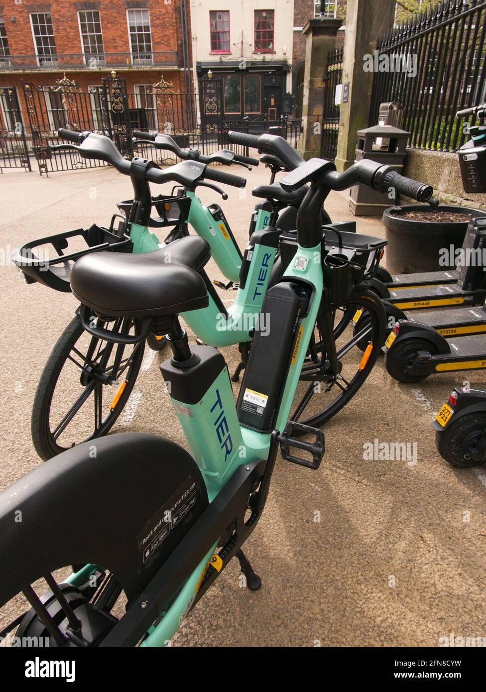 A bay of hireable TIER e-scooters and e-bikes next to the council offices  in central York, North Yorkshire Stock Photo - Alamy