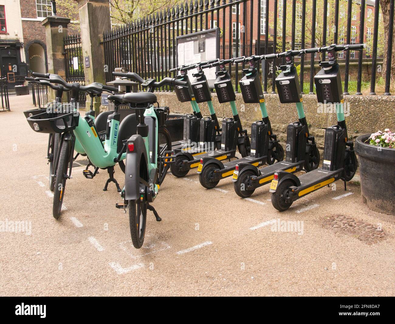 A bay of hireable TIER escooters and ebikes next to the council