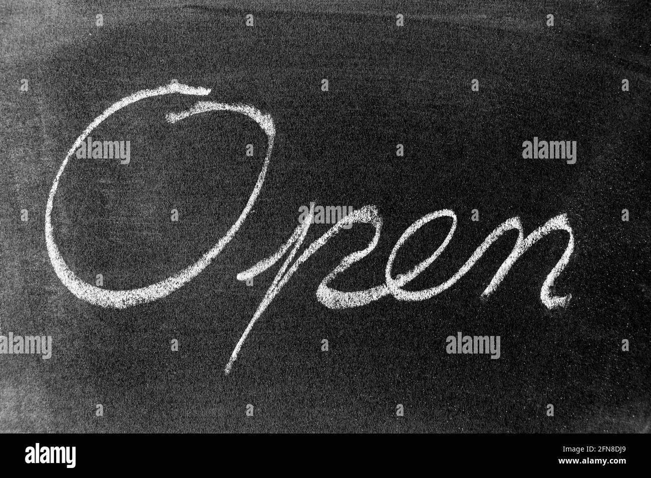 White color chalk as handwriting in word open on blackboard background ...