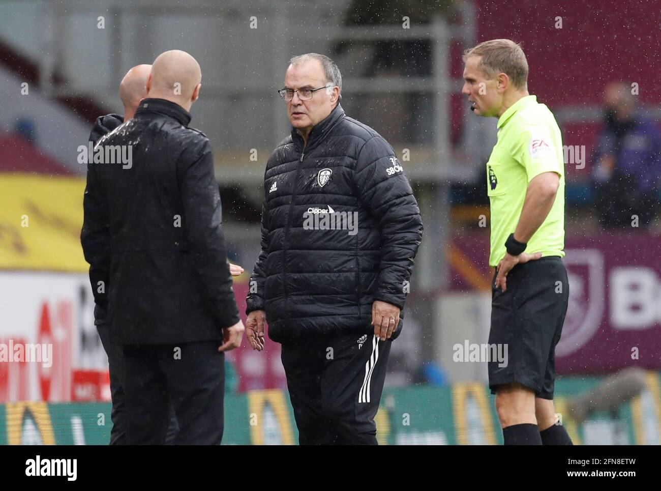 Burnley, UK. 15th May, 2021. Referee Graham Scott has words with Sean Dyche manager of Burnley and Marcelo Bielsa manager of of Leeds United during the Premier League match at Turf Moor, Burnley. Picture credit should read: Darren Staples/Sportimage Credit: Sportimage/Alamy Live News Stock Photo