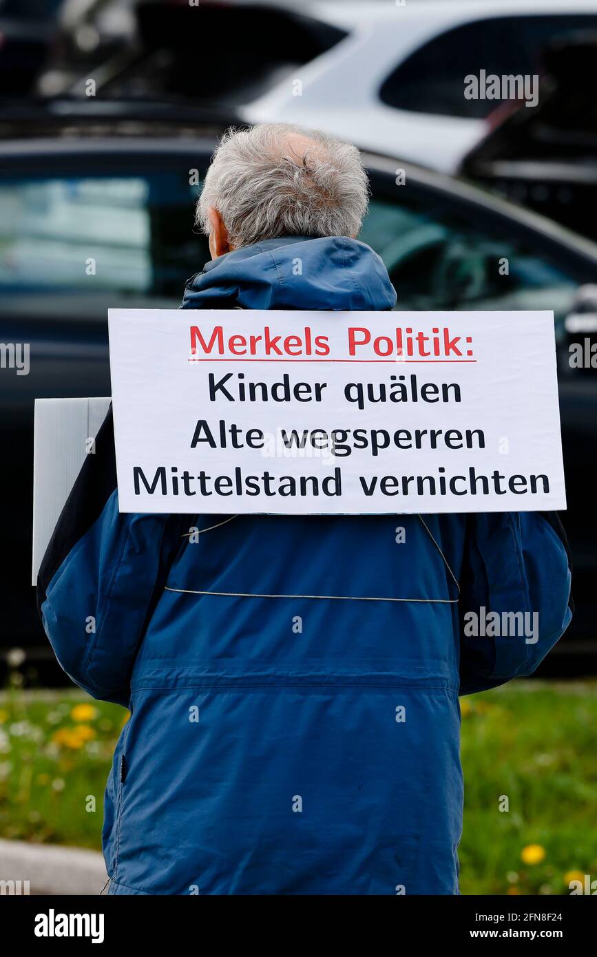 Kiel, Germany. 15th May, 2021. A man carries a sign reading 'Merkel's policies: torture children, lock away the old, destroy the middle class' during a demonstration by the so-called lateral thinkers scene. Credit: Frank Molter/dpa/Alamy Live News Stock Photo