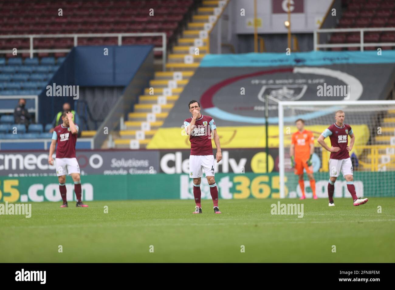 Burnley players look dejected after Leeds United's Rodrigo scores the side's fourth goal of the game during the Premier League match at Turf Moor, Burnley. Picture date: Saturday May 15, 2021. Stock Photo