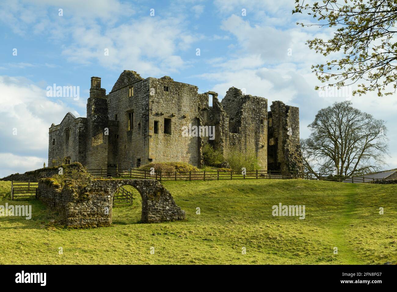 Barden Tower (sunlight on beautiful historic ancient hunting lodge ruin & blue sky) - scenic rural Bolton Abbey Estate, Yorkshire Dales, England UK. Stock Photo