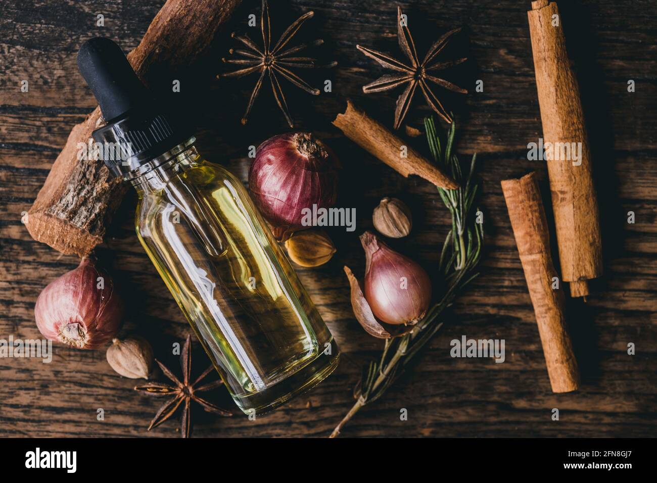 Herbal oil extract for food or aroma on wooden table decoration with scent herb. Stock Photo