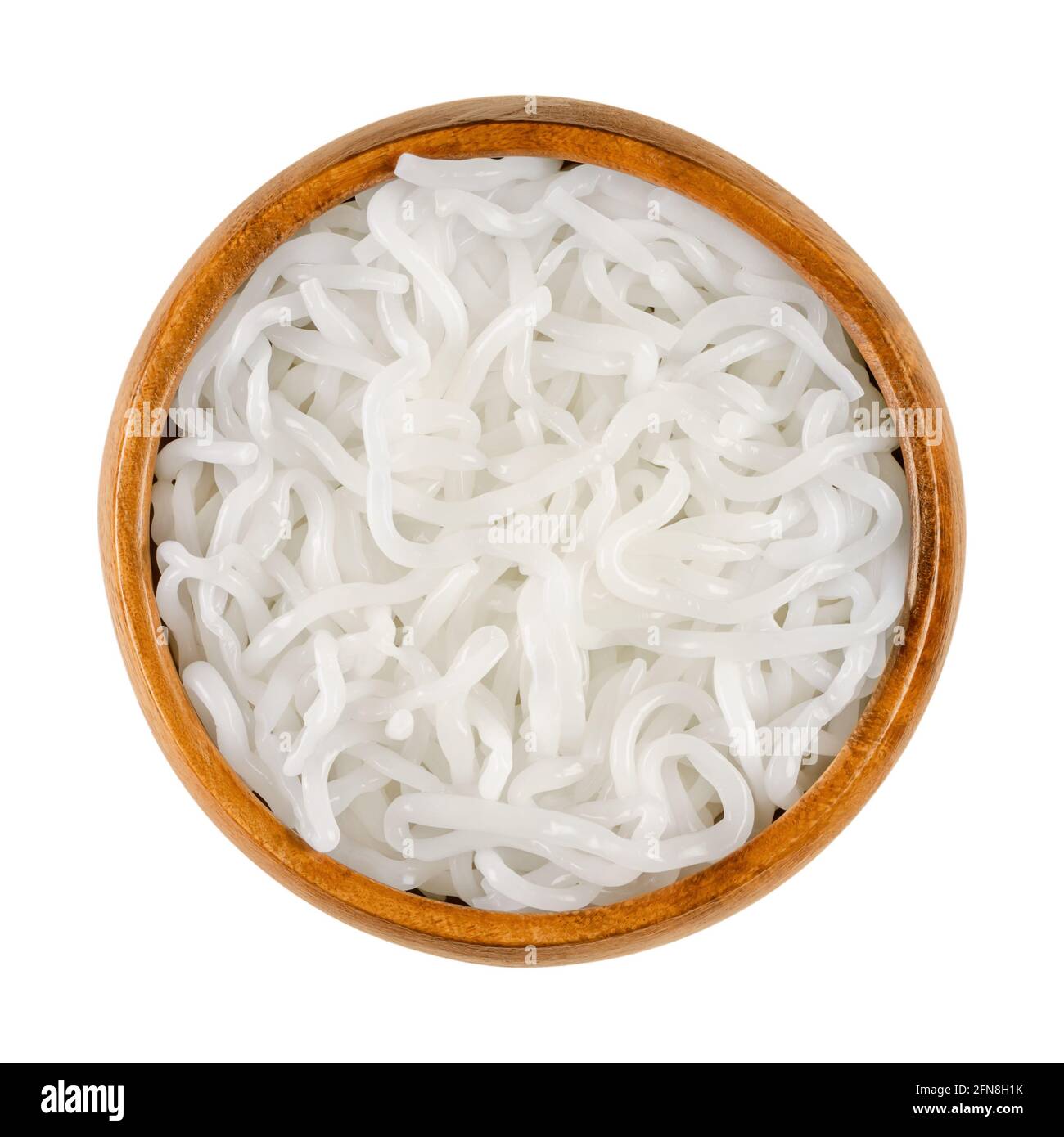 Diet pasta made from alginates, in a wooden bowl. Zero calorie noodles, made of kelp, brown algae seaweeds. Stock Photo