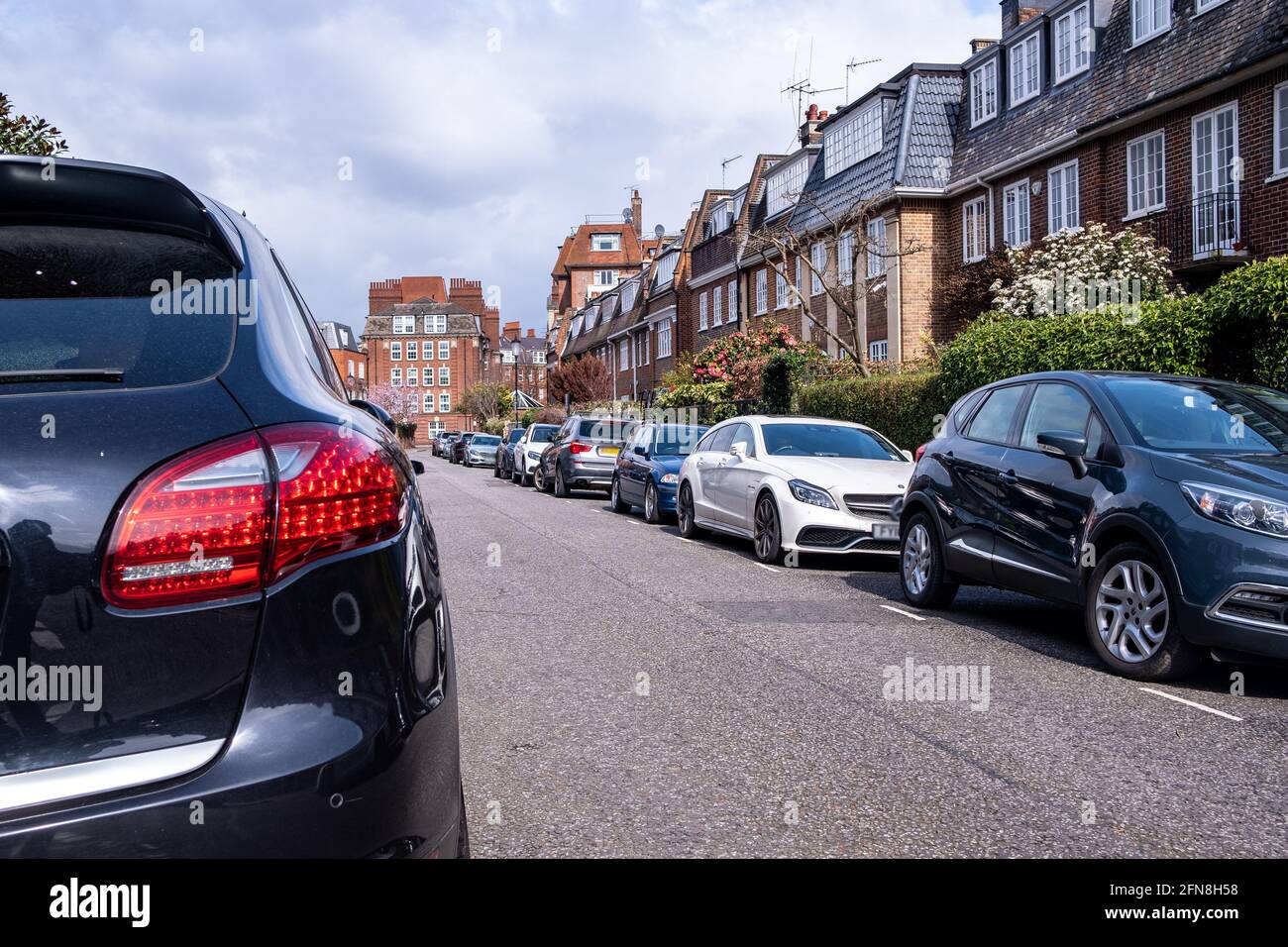 Cars parked on street of upmarket expensive houses in Chelsea. Stock Photo