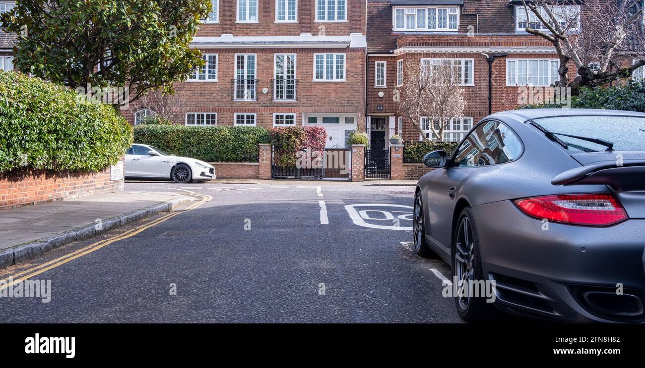 Car parked on British street of urban housing Stock Photo