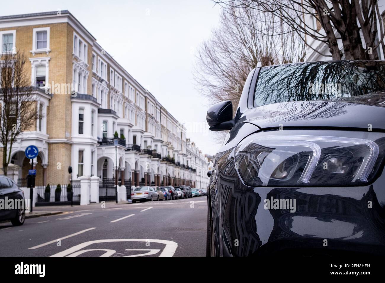 Car parked on British street of urban housing Stock Photo