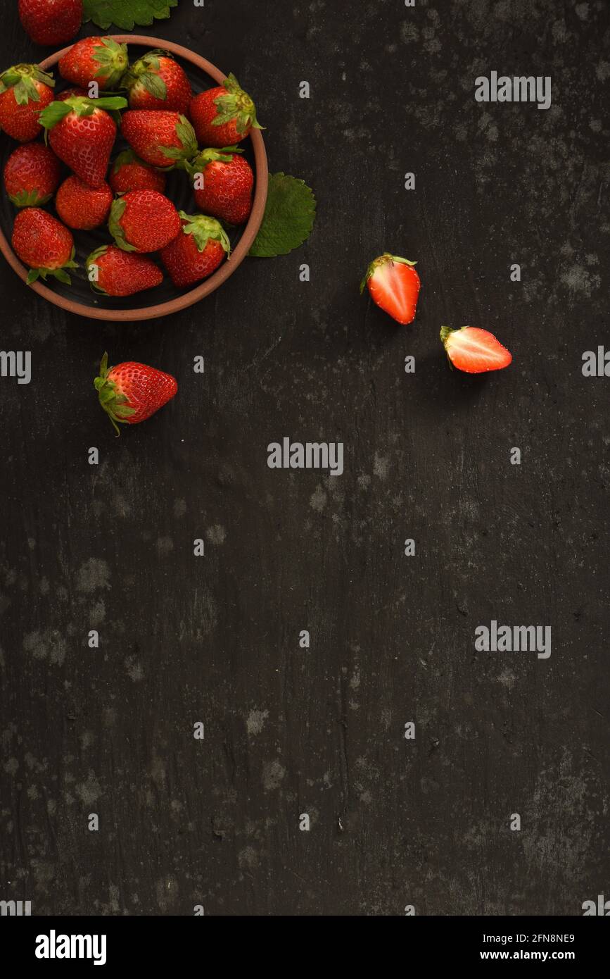 Dark Black Strawberry Cranberry In Bowl Food Flat Lay with Cutting Board and Cloth Stock Photo