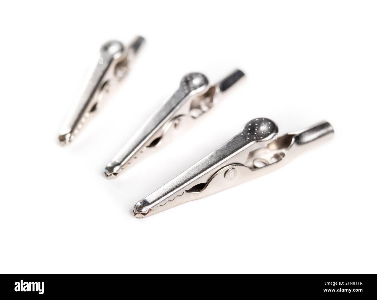 Group of alligator clips or craft wire clips. Perspective view. Used for  creating a temporary electrical connection or for crafts holding photos,  memo Stock Photo - Alamy