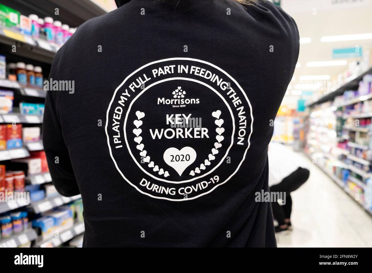 Morrisons supermarket worker Keyworker 2020 wearing sign 'I Played My Full Part in Feeding the Nation During Covid-19' pandemic UK   KATHY DEWITT Stock Photo