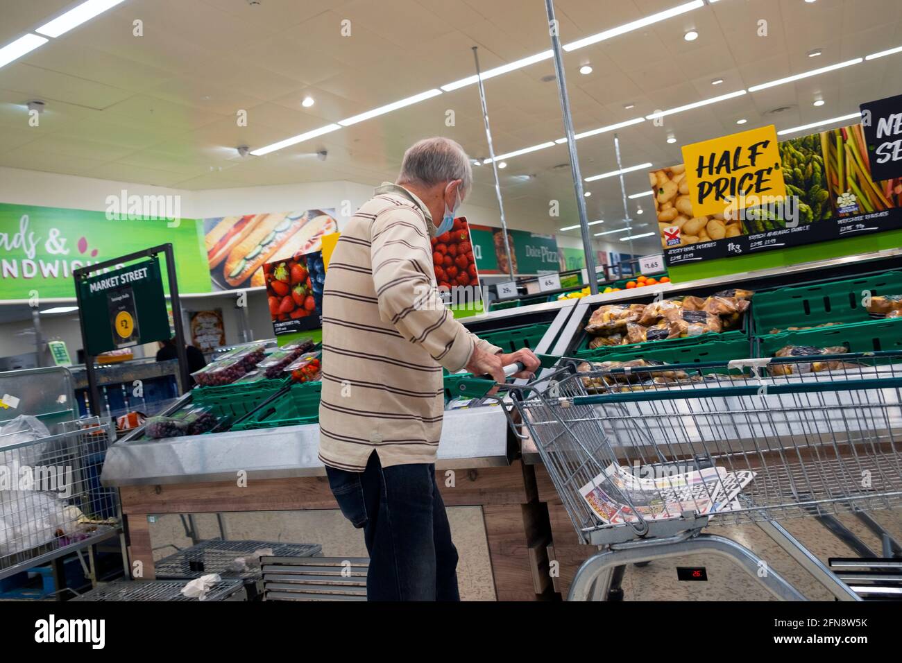 Customers shoppers people wearing face masks while shopping during Covid 19 pandemic in