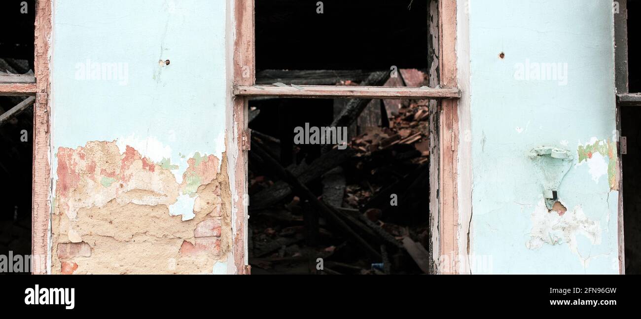 Wall with a window of an old destroyed house Stock Photo