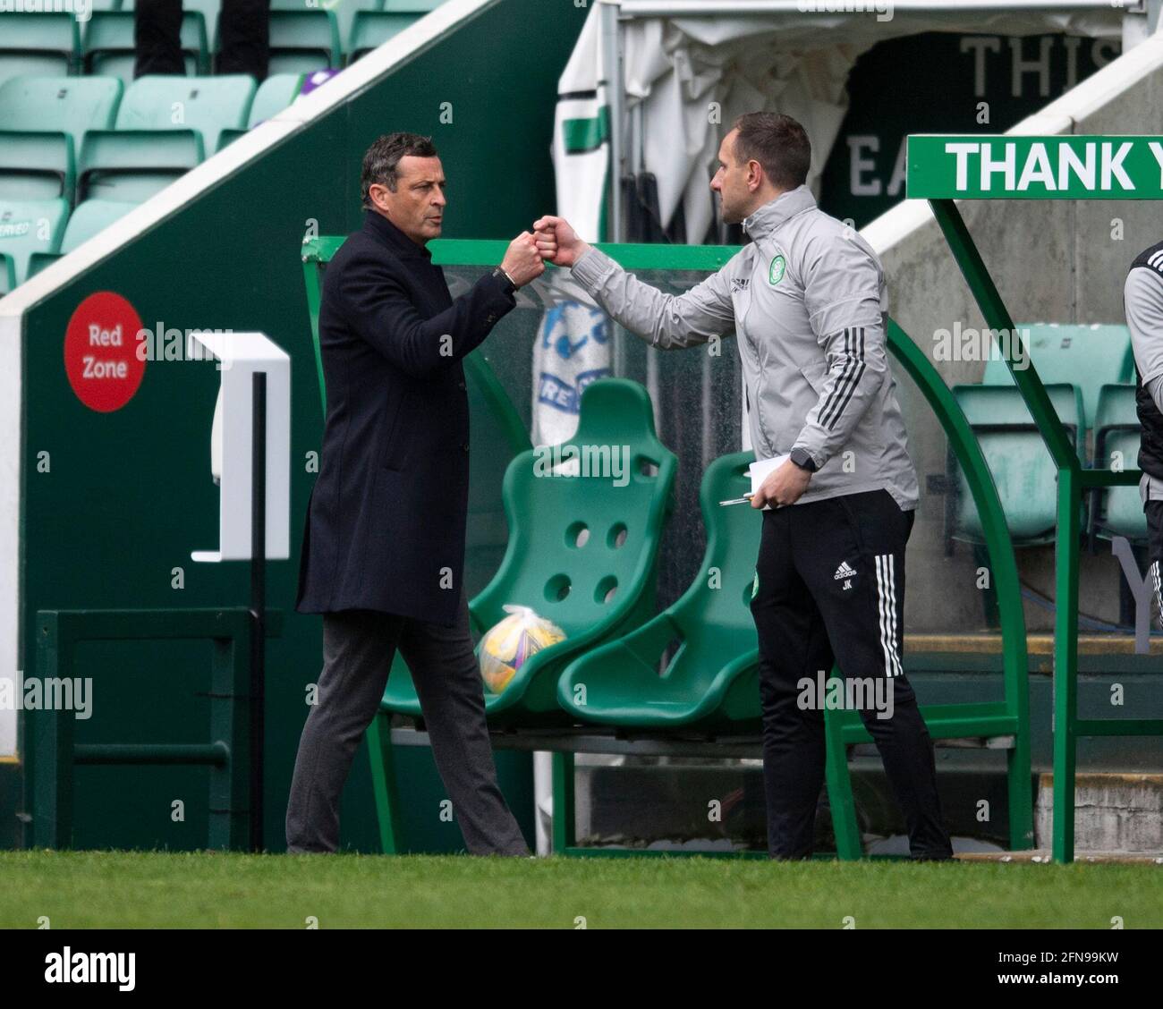 Scottish Premiership - Hibernian v Celtic. Easter Road Stadium, Edinburgh, Midlothian, UK. 15th May, 2021. Hibs play host to Celtic in the Scottish Premier League at Easter road, Edinburgh. Pic shows: HibsÕ Manager, Jack Ross, and Celtic's interim manager, John Kennedy, bump fists at the end of the game. Credit: Ian Jacobs/Alamy Live News Stock Photo