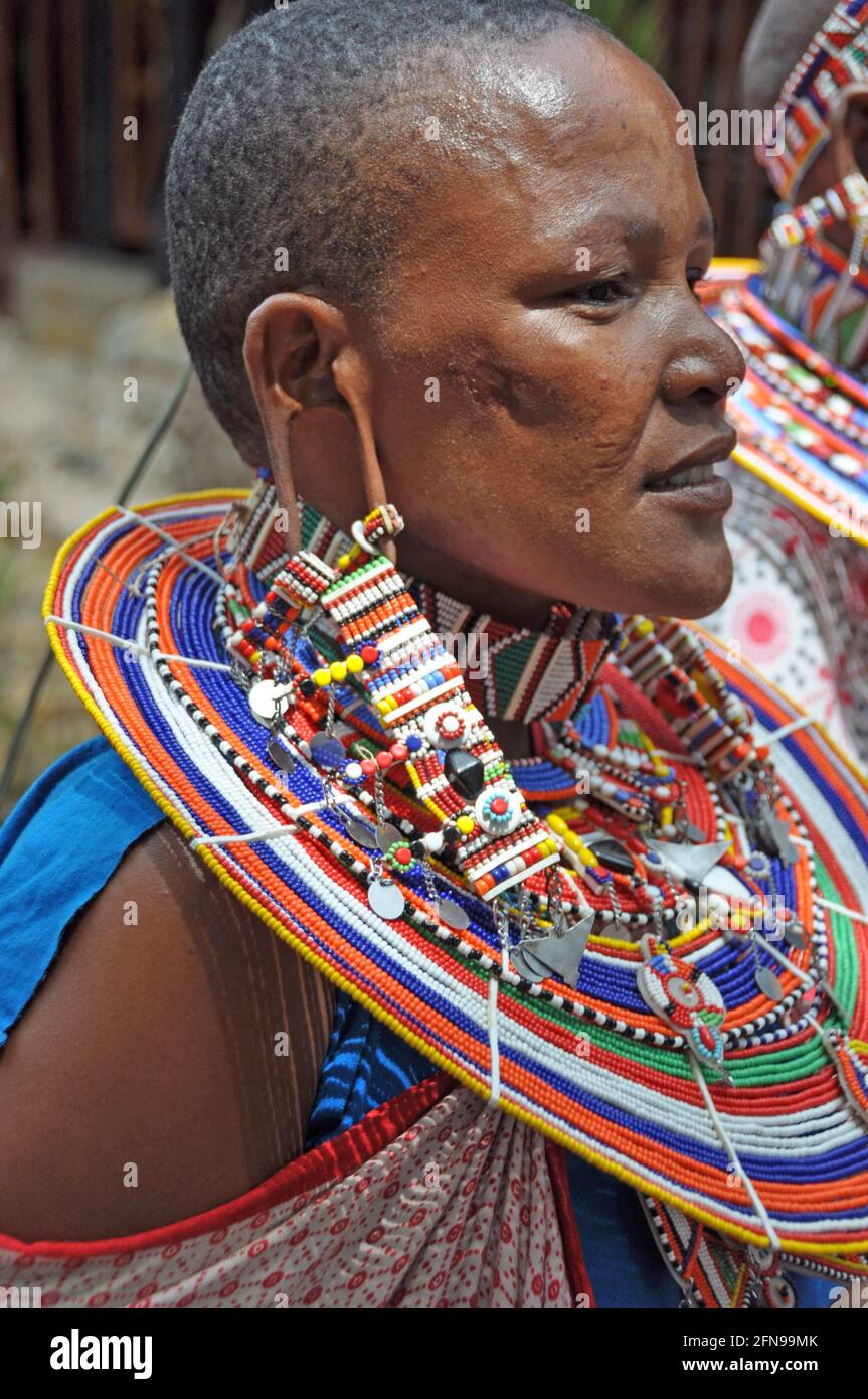 Beautifull Masai Women with tradition colour glass perls around her neck. Hübsche Masai-Frau mit traditionellem Glasperlenschmuck Stock Photo