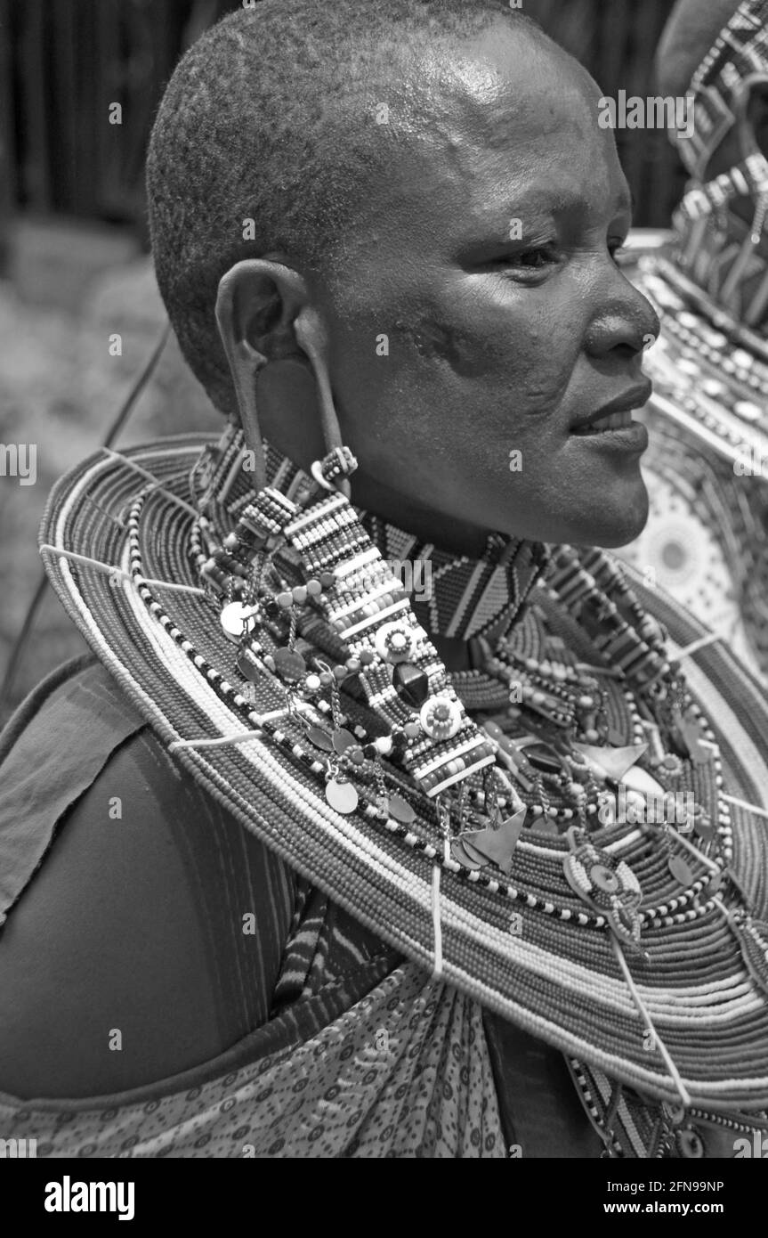Beautifull Masai Women with tradition colour glass perls around her neck. Hübsche Masai-Frau mit traditionellem Glasperlenschmuck Stock Photo