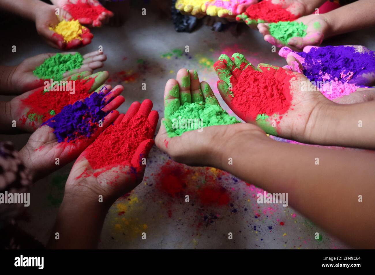 multiple colored powder on hands for holiday Stock Photo