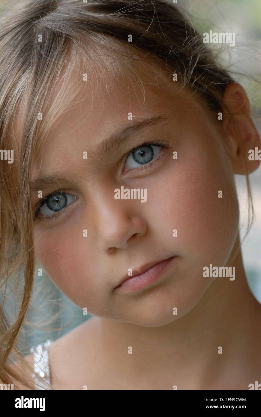 Little girl blonde hair, blue eyes and white dress, that makes grimaces,  italian little girl, Italy Stock Photo - Alamy