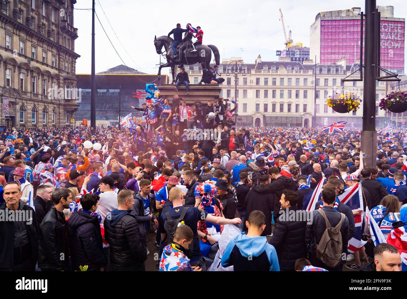 Glasgow, Scotland, UK. 15 May 2021. Thousands of supporters and fans of Rangers football club descend into George Square in Glasgow to celebrate winning the Scottish Premiership championship for the 55th time and the first time for 10 years.Iain Masterton/Alamy Live News Stock Photo