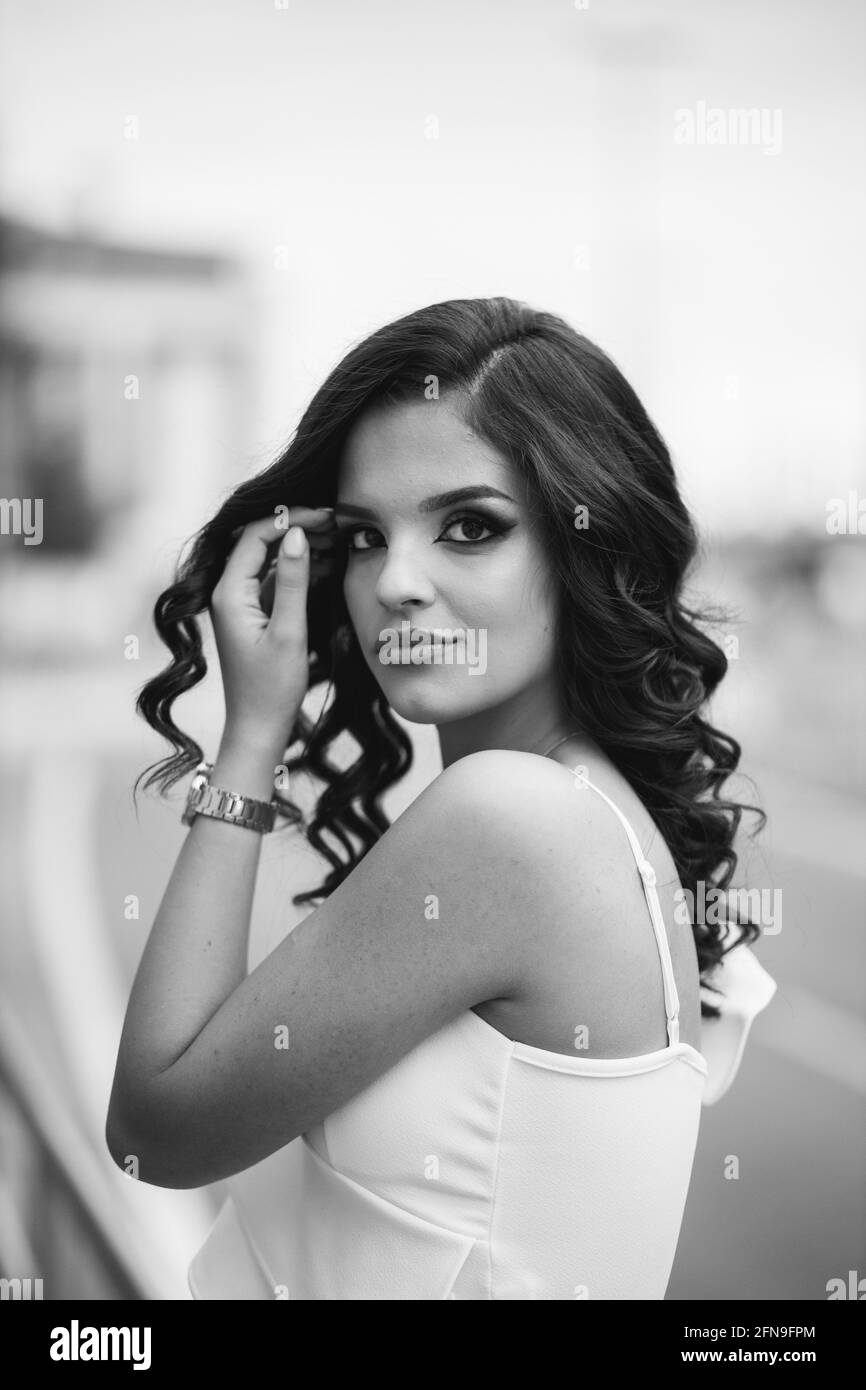 grayscale-of-a-gorgeous-caucasian-female-with-curly-hair-posing-on