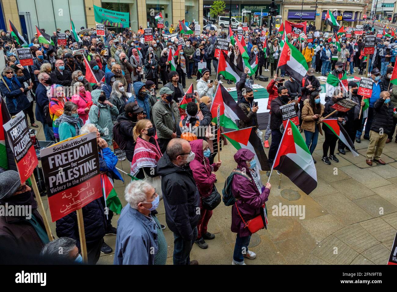 Sheffield, UK- May 15th 2021: Protesters hold placards and flags during a 'Sheffield Palestine Solidarity Campaign' protest outside Sheffield Town Hall in the city centre. The protestors were demonstrating against the recent attacks by Israeli military forces against Palestines in the Gaza Strip and clashes in East Jerusalem. Credit: Mark Harvey/Alamy Live News Stock Photo