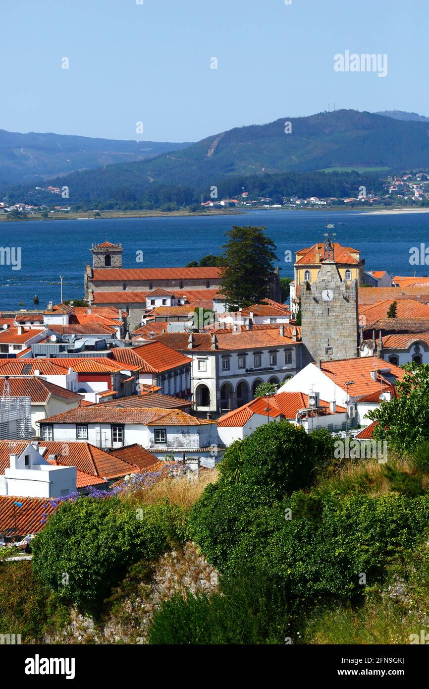 View of town with Clock Tower (R) and Igreja Matriz (L), Rio Minho in background, Caminha, Minho Province, Portugal Stock Photo