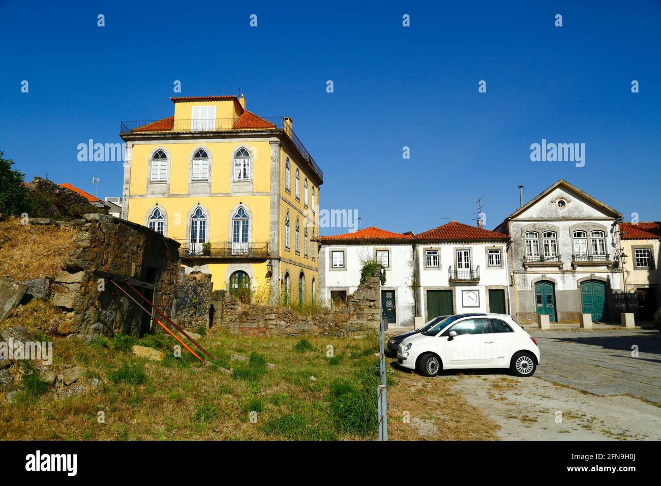 Collapsing section of old town defensive wall with supports next to parish church / Igreja Matriz, Caminha, Minho Province, Portugal Stock Photo