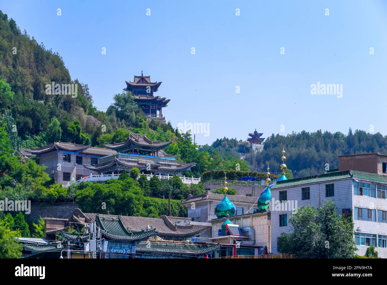 Skyline of Lanzhou City in Northern China. Hui Mosque and Minaret overlooking Cityscape and Yellow River. Stock Photo