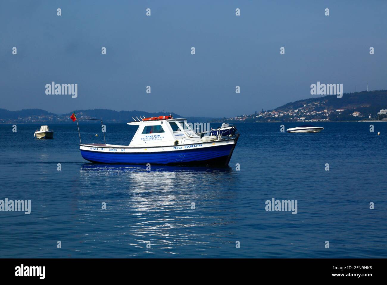 Fishing boast moored in River Minho estuary near Caminha (in background), Minho Province, Portugal Stock Photo