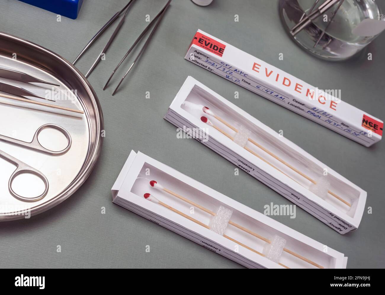 Several boxes of swabs with traces of blood for murder investigation in crime lab, concept image Stock Photo